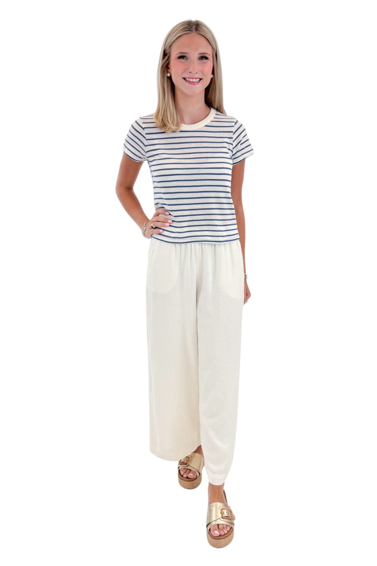 Front view of woman wearing Swagger Boutique’s True Navy Junie Striped Tee by Z Supply with White Scout Linen Pants by Z Supply against white studio background.
