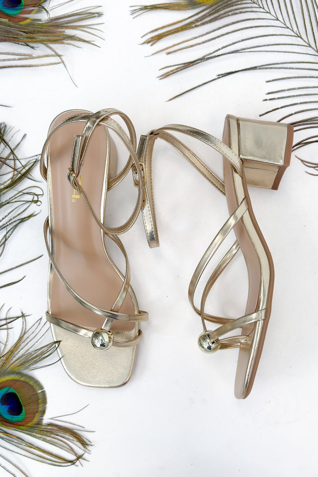 Tuari- Gold Ball Detail Cross Strap Heels against studio background