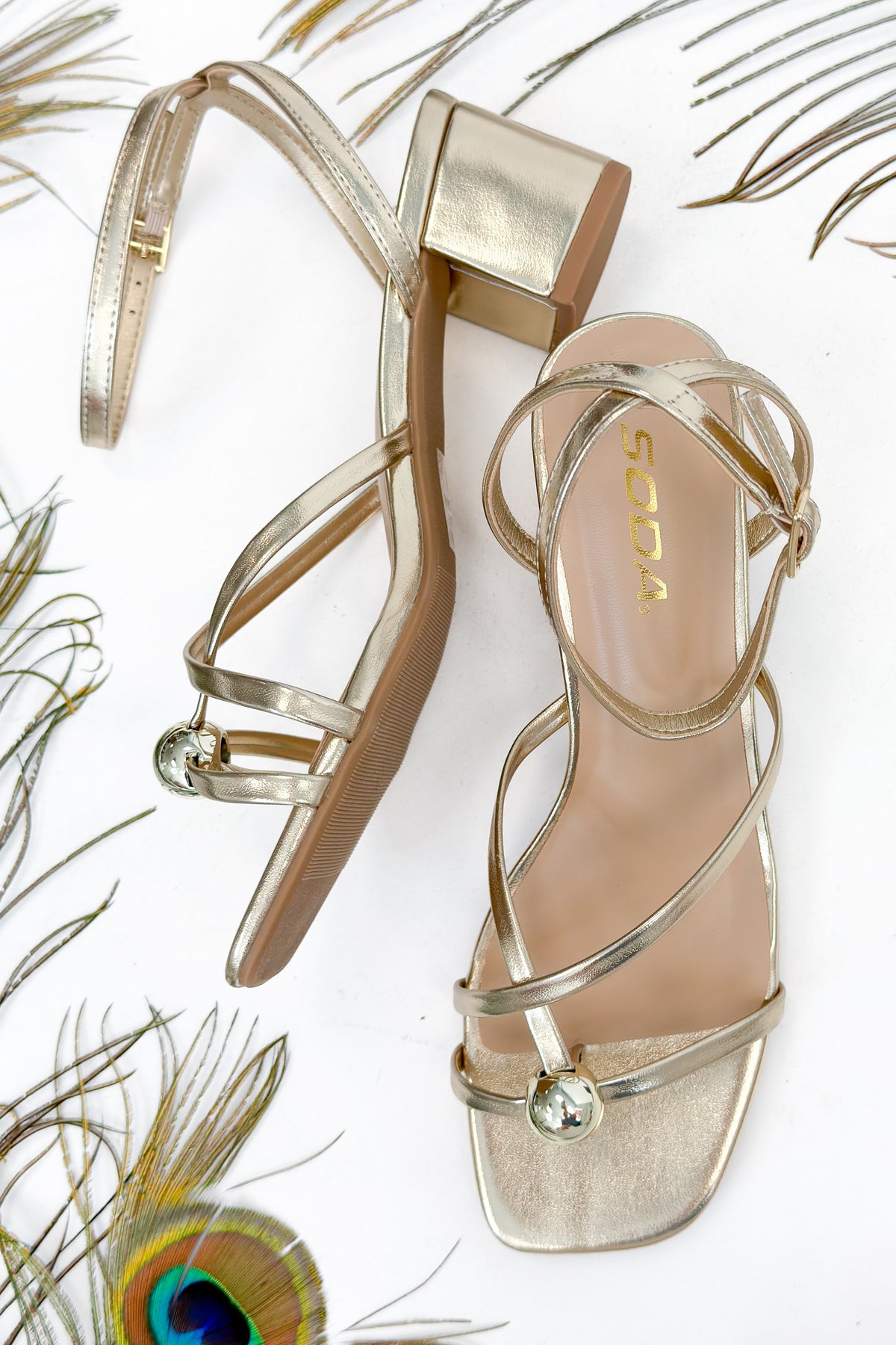 Tuari- Gold Ball Detail Cross Strap Heels against studio background