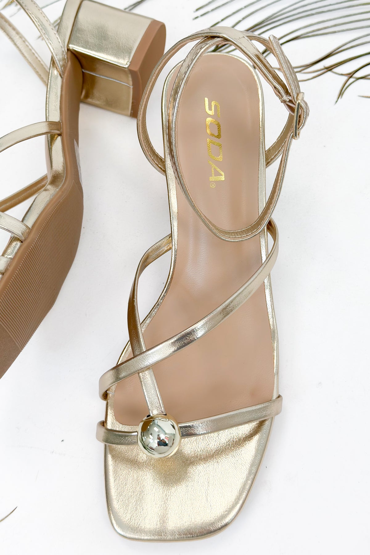 Tuari- Gold Ball Detail Cross Strap Heels against studio background