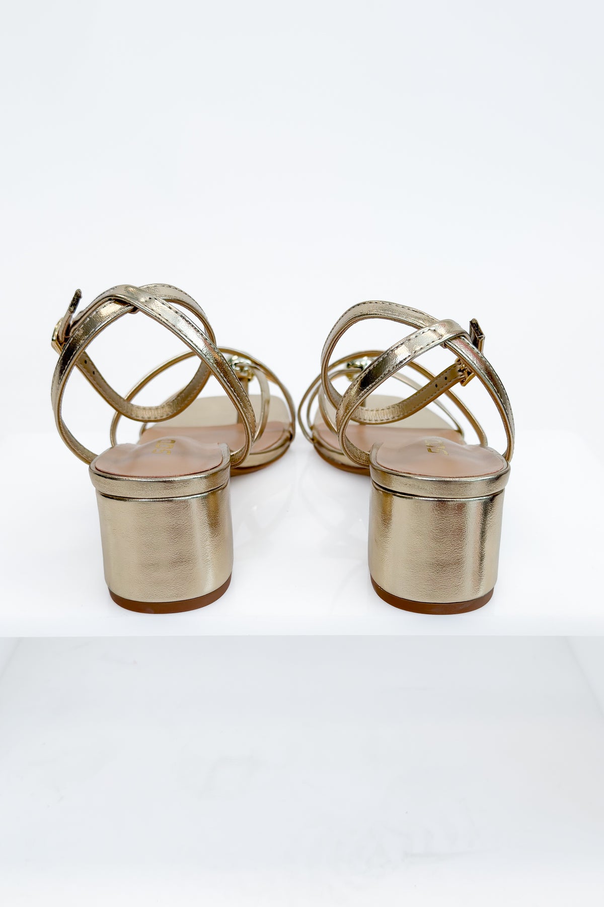 Tuari- Gold Ball Detail Cross Strap Heels against studio background back view.