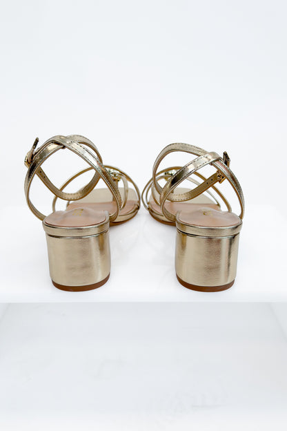 Tuari- Gold Ball Detail Cross Strap Heels against studio background back view.