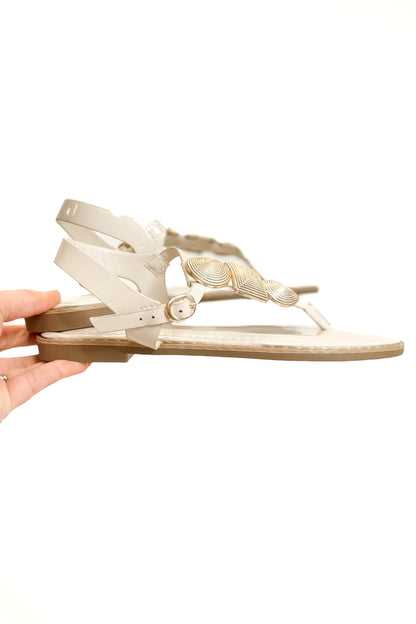 Twinkle- Bone With Gold Charms Sandal against white studio background side view.
