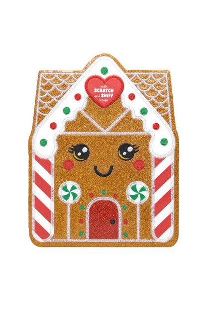 Gingerbread house-shaped scratch and sniff book with a heart label on a white background
