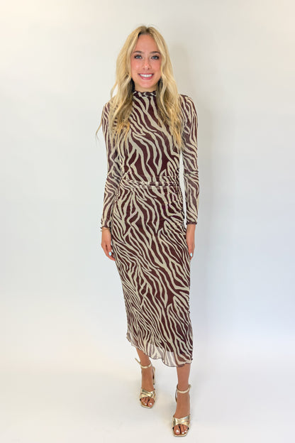 Front view of woman wearing Swagger Boutique’s Velvet Rouge Sevilla Zebra Mesh Midi Dress by Z Supply with heels against white studio background.
