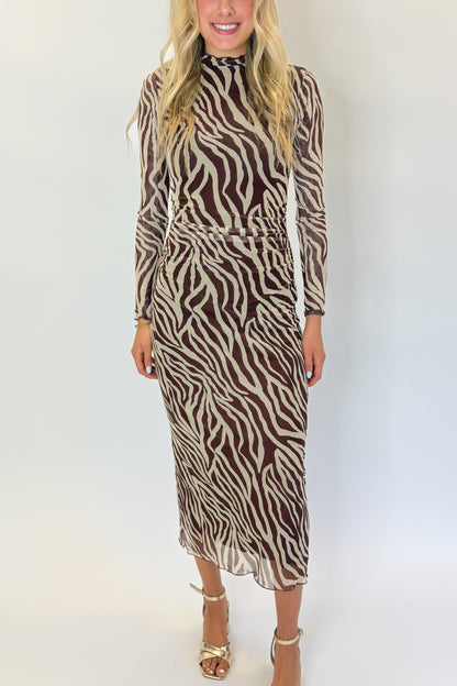 Front detail view of woman wearing Swagger Boutique’s Velvet Rouge Sevilla Zebra Mesh Midi Dress by Z Supply with heels against white studio background.