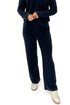 Front view of woman wearing Black Ribbed Lounge Pants with matching top against white studio background.