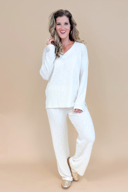 Model wearing cream ribbed lounge pants and matching long sleeve top.