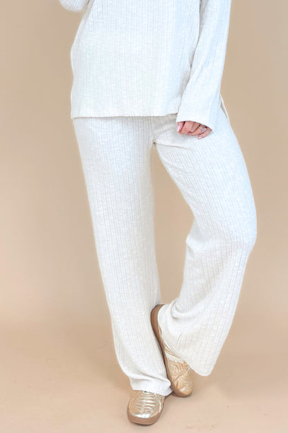 Model wearing cream ribbed lounge pants and matching long sleeve top.