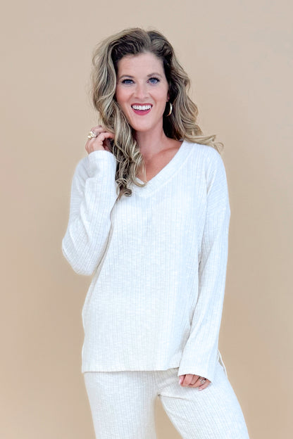 Model wearing cream ribbed lounge long sleeve top.