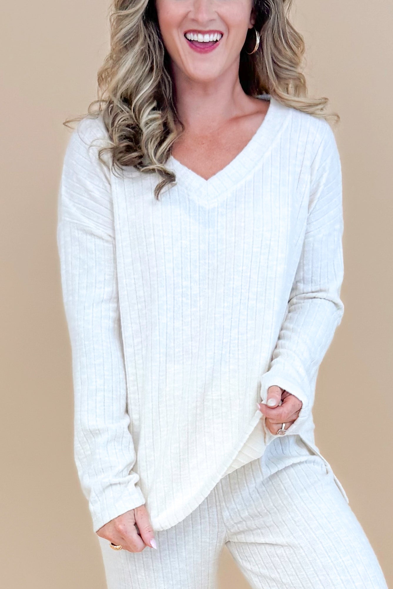 Model wearing cream ribbed lounge long sleeve top.