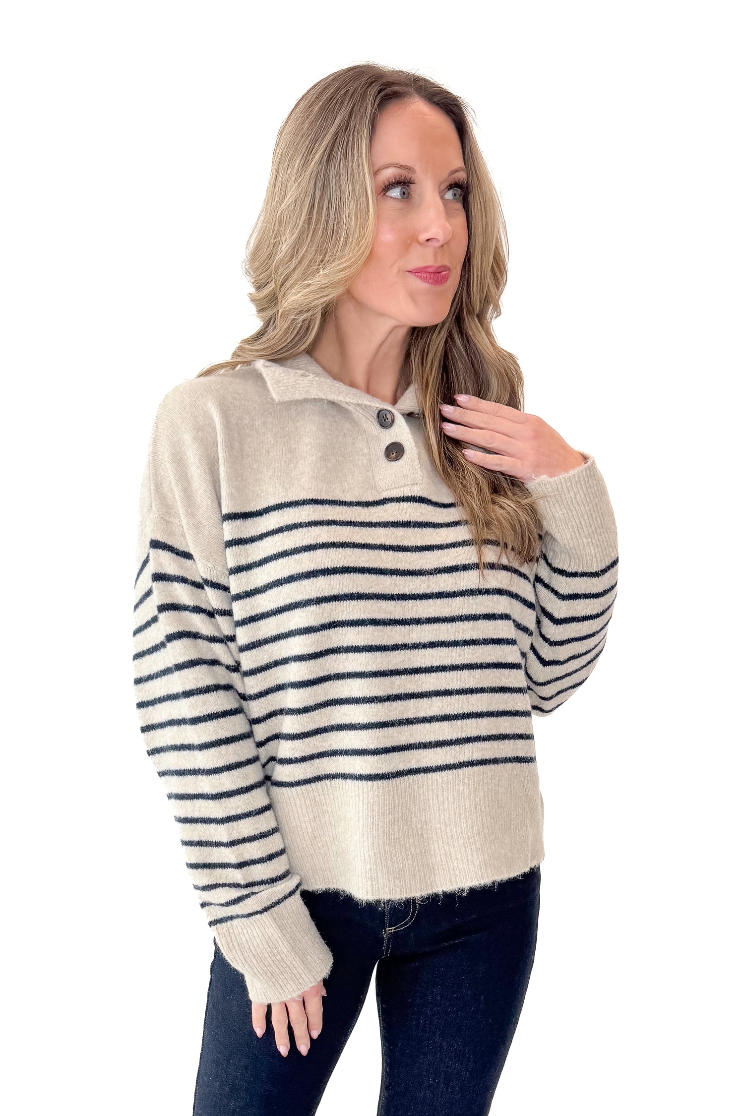 Front view of woman wearing Oatmeal and Navy Striped Button Detail Sweater with jeans against white studio background.
