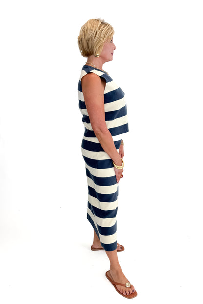 Side view of woman wearing Navy &amp; Cream Striped Midi Skirt with matching tank against white studio background.