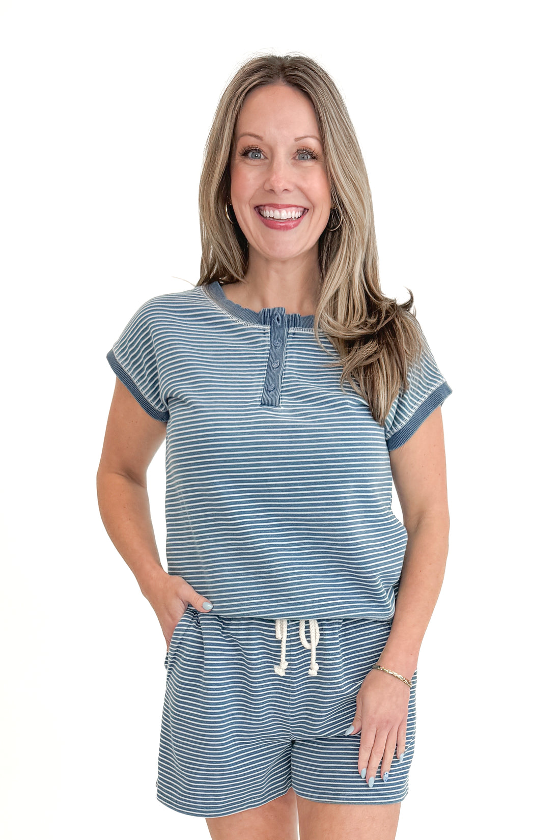 Front view of woman wearing Washed Blue Striped Drawstring Shorts with matching top against white studio background.