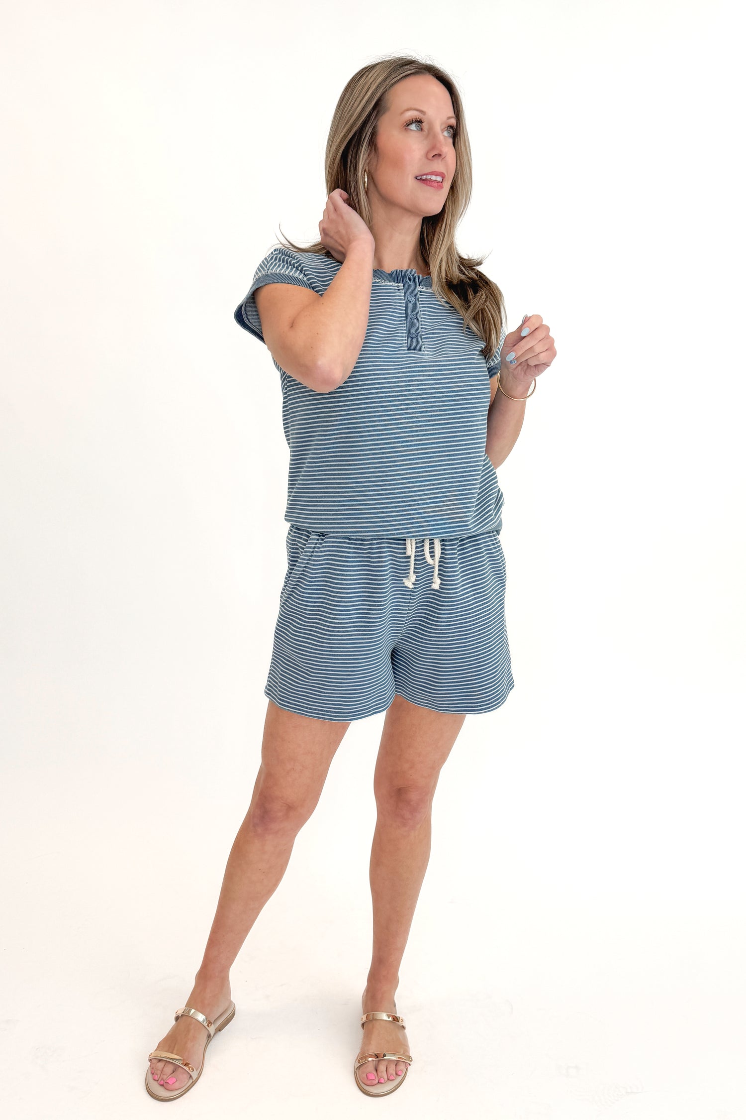 Front view of woman wearing Washed Blue Striped Drawstring Shorts with matching top against white studio background.