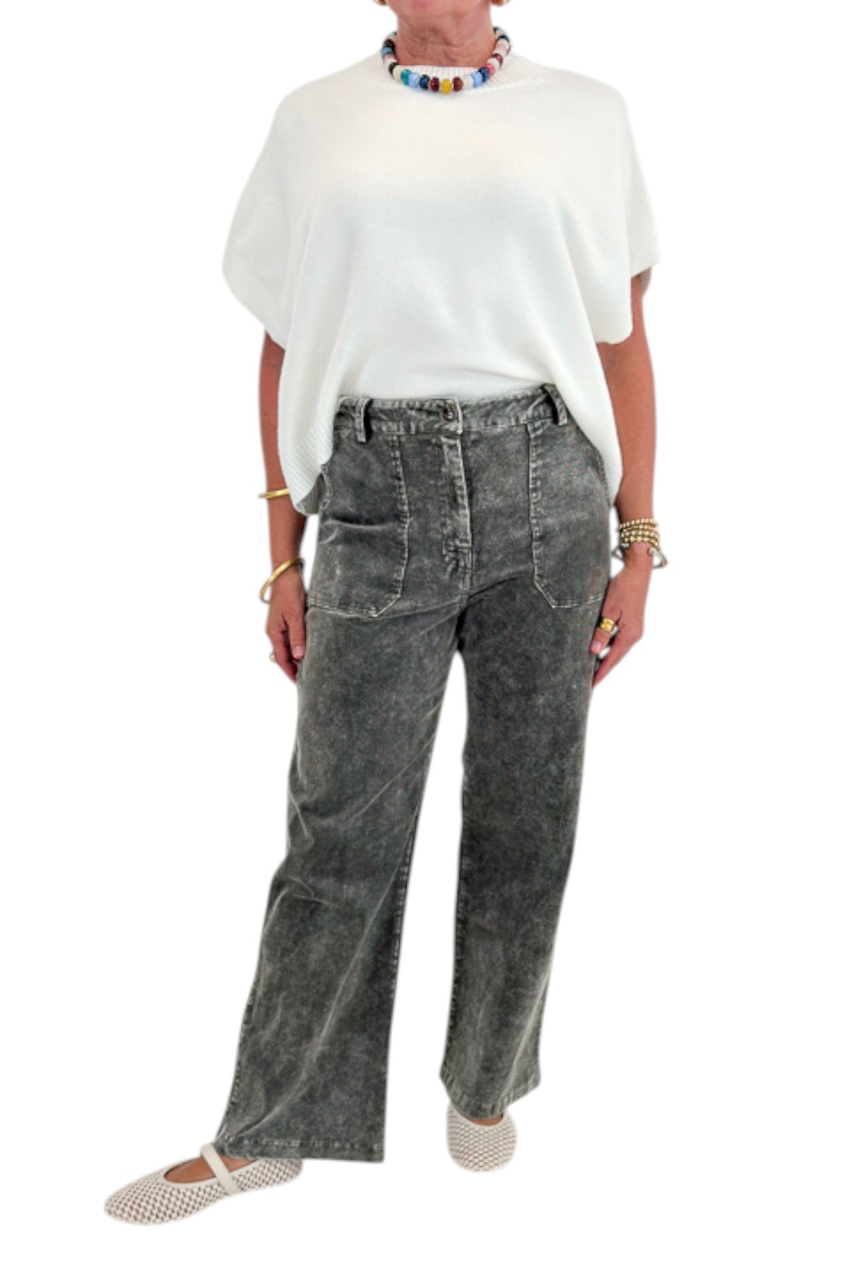 Front detail view of woman wearing Swagger Boutique’s Ivory Light Weight Short Sleeve Sweater with Washed Stone Corduroy Pants against white studio background.