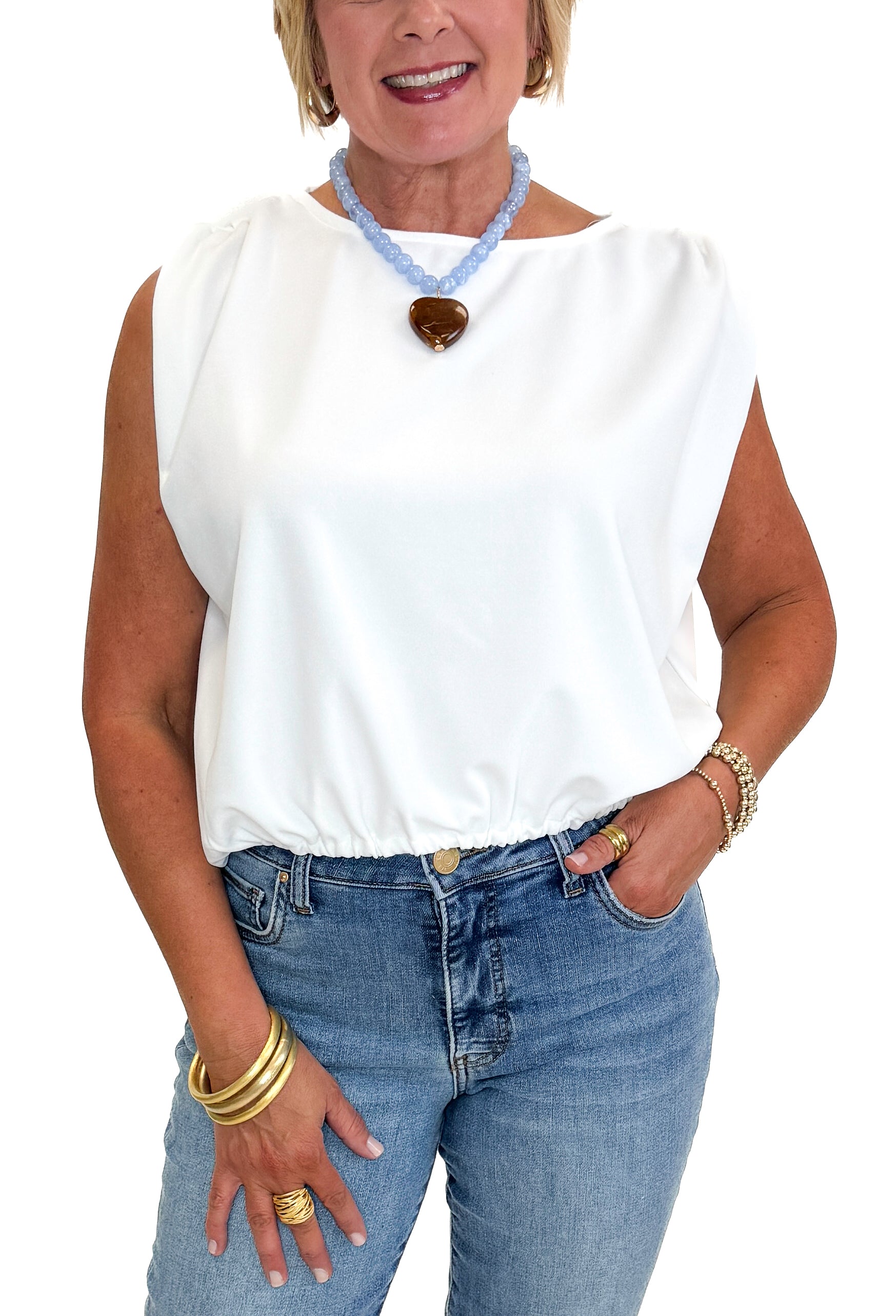 Front detail view of woman wearing Swagger Boutique’s White Bubble Hem Tank with jeans against white studio background.
