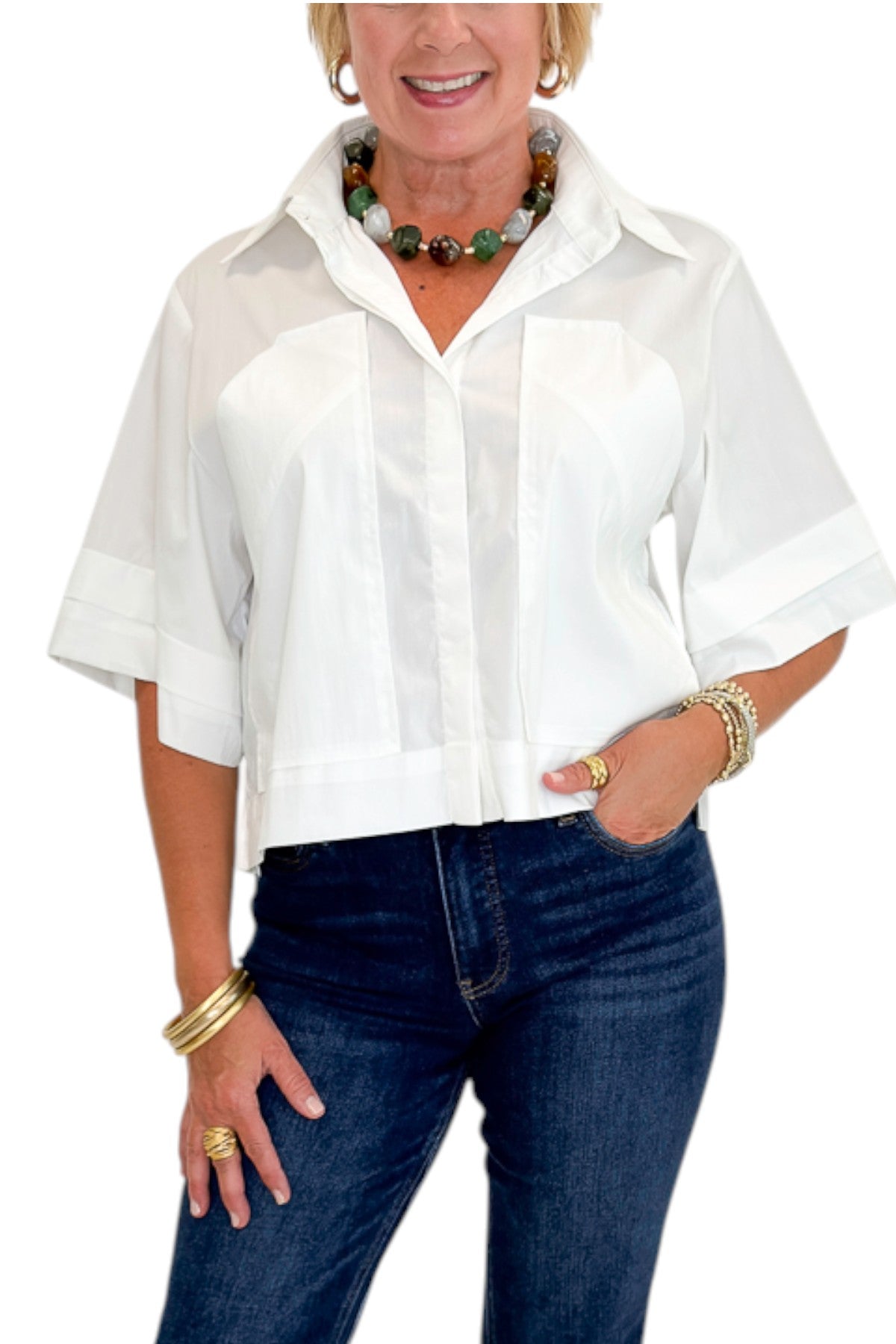 Front detail view of woman wearing Swagger Boutique’s White Collared Short Sleeve Top with jeans against white studio background.