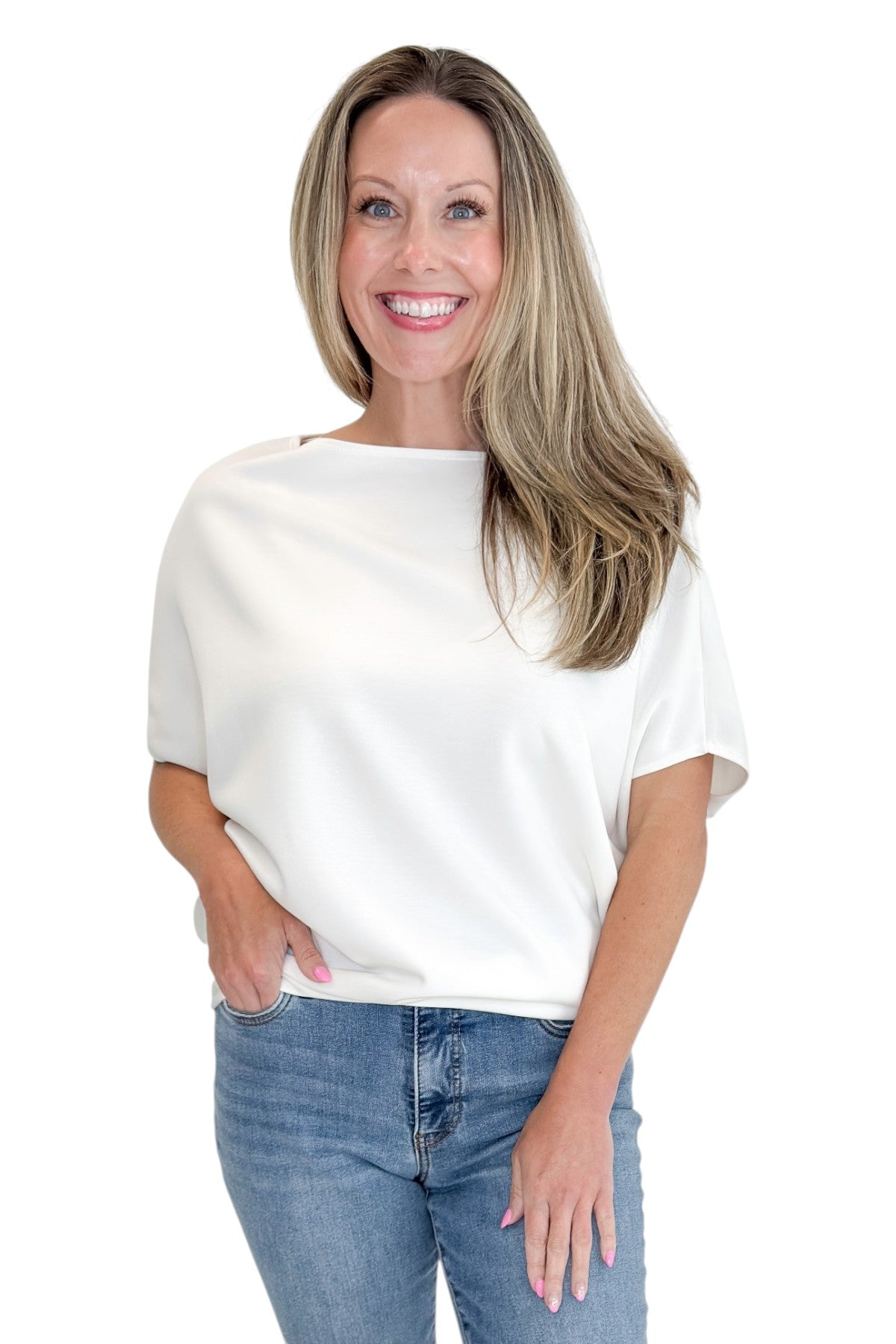 Front view of woman wearing Swagger Boutique’s Off White Dolman Sleeve Top with jeans against white studio background.