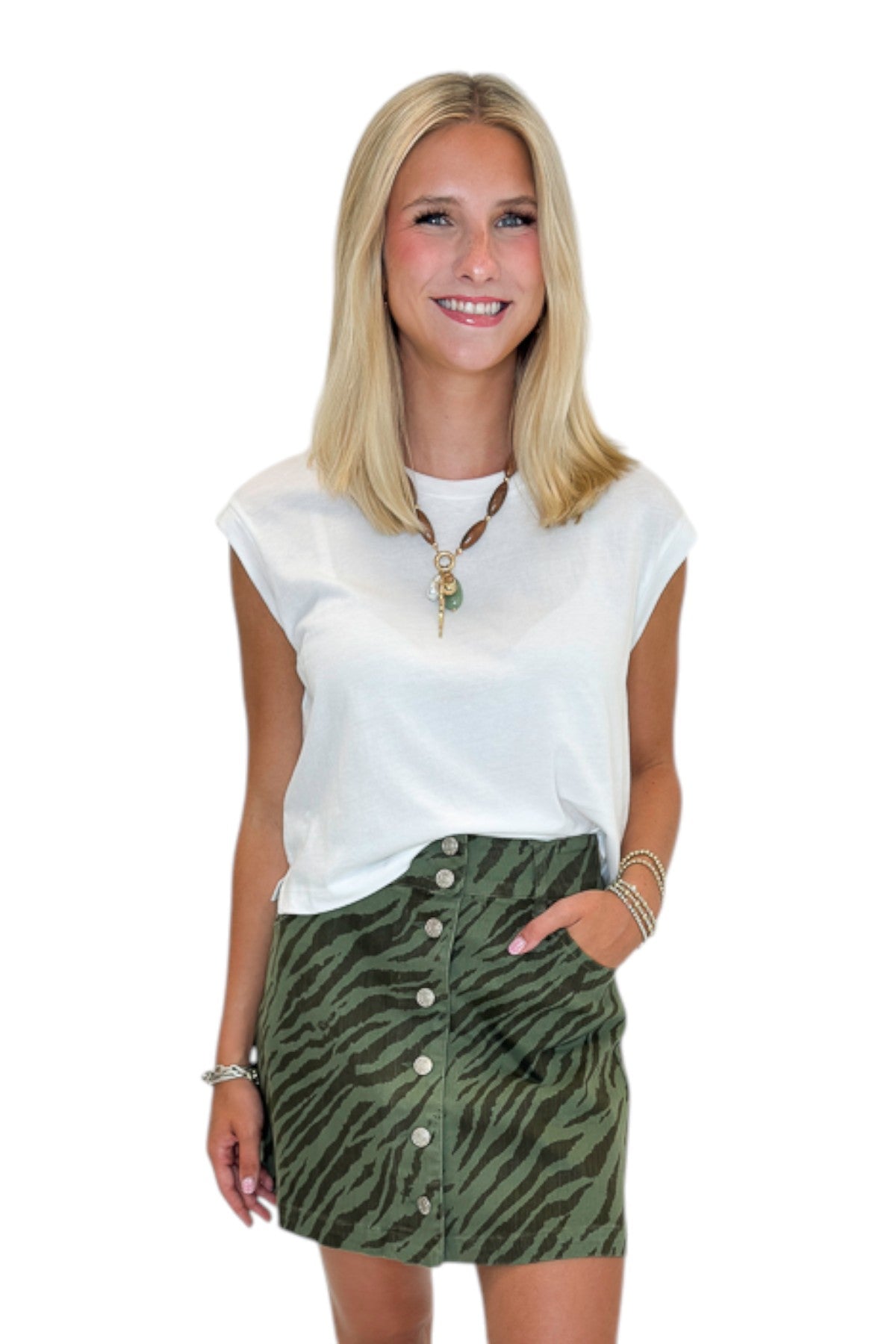 Front view of woman wearing Swagger Boutique’s White Flex Sleeveless Tee by Z Supply against white studio background.
