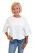 Front view of woman wearing Swagger Boutique’s White Floral Embroidered Short Sleeve Sweatshirt by Entro with jeans against white studio background.