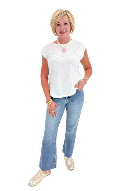 Front view of woman wearing Swagger Boutique’s White Sol Slub Tank by Z Supply with jeans against white studio background.