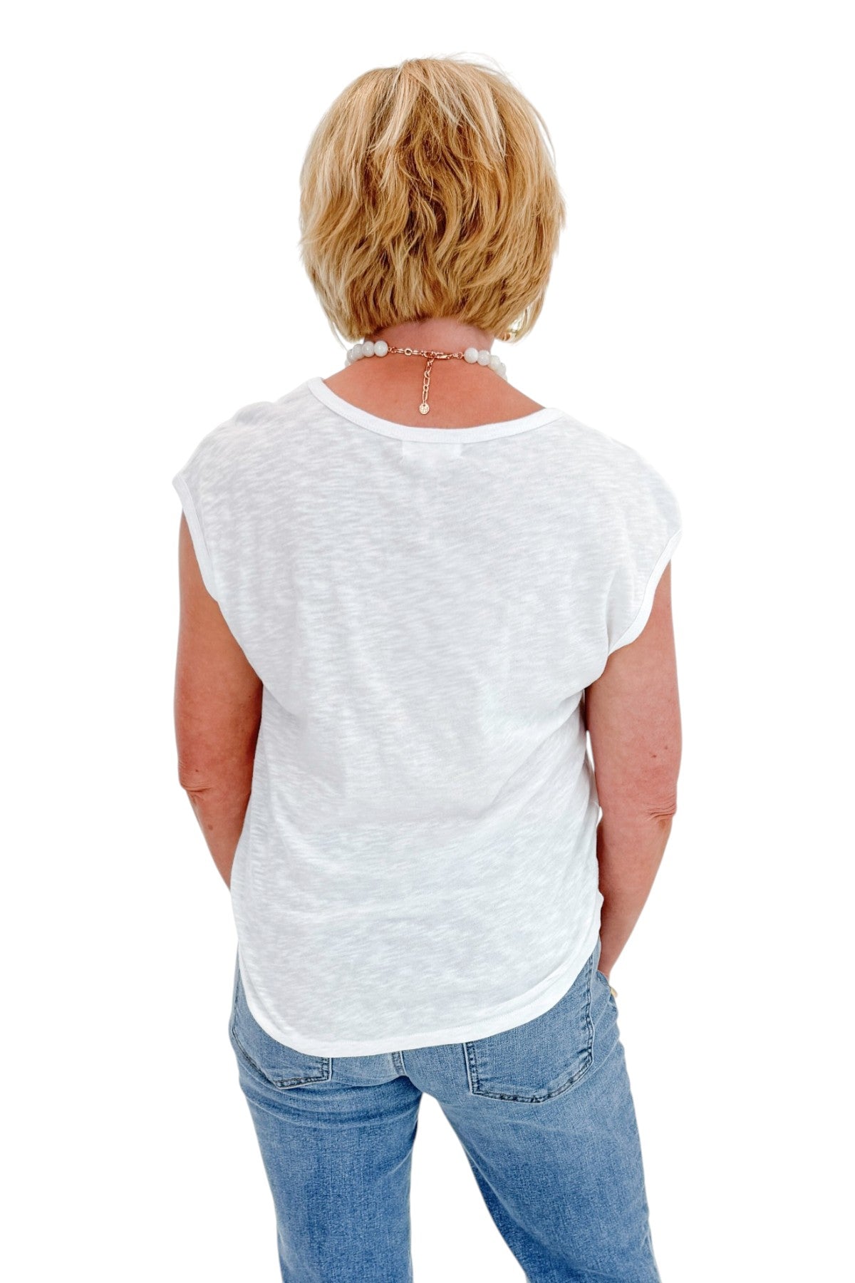 Back view of woman wearing Swagger Boutique’s White Sol Slub Tank by Z Supply with jeans against white studio background.