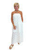 Front view of woman wearing Swagger Boutique’s White Strapless Eyelet Midi Dress by Entro with sandals against white studio background.