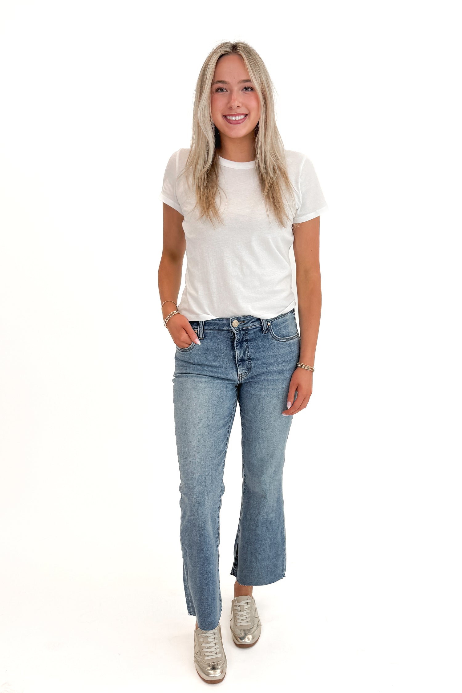 Front view of woman wearing Swagger Boutique’s White Tourist Tee by Z Supply with jeans against white studio background.