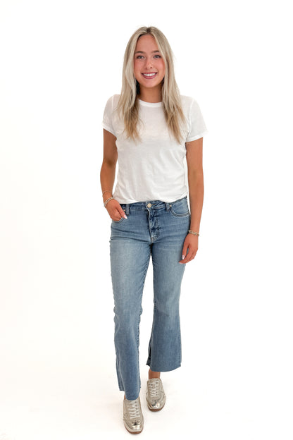 Front view of woman wearing Swagger Boutique’s White Tourist Tee by Z Supply with jeans against white studio background.