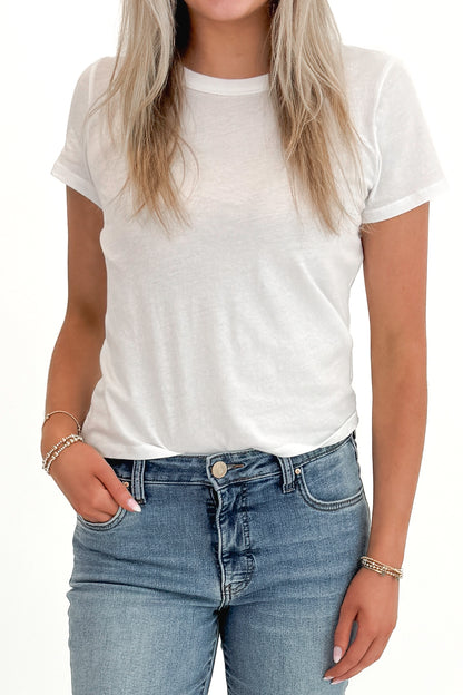 Front detail view of woman wearing Swagger Boutique’s White Tourist Tee by Z Supply with jeans against white studio background.
