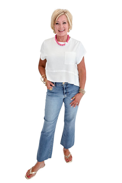 Front view of woman wearing Swagger Boutique’s White Waffle Knit Tee with jeans against white studio background.