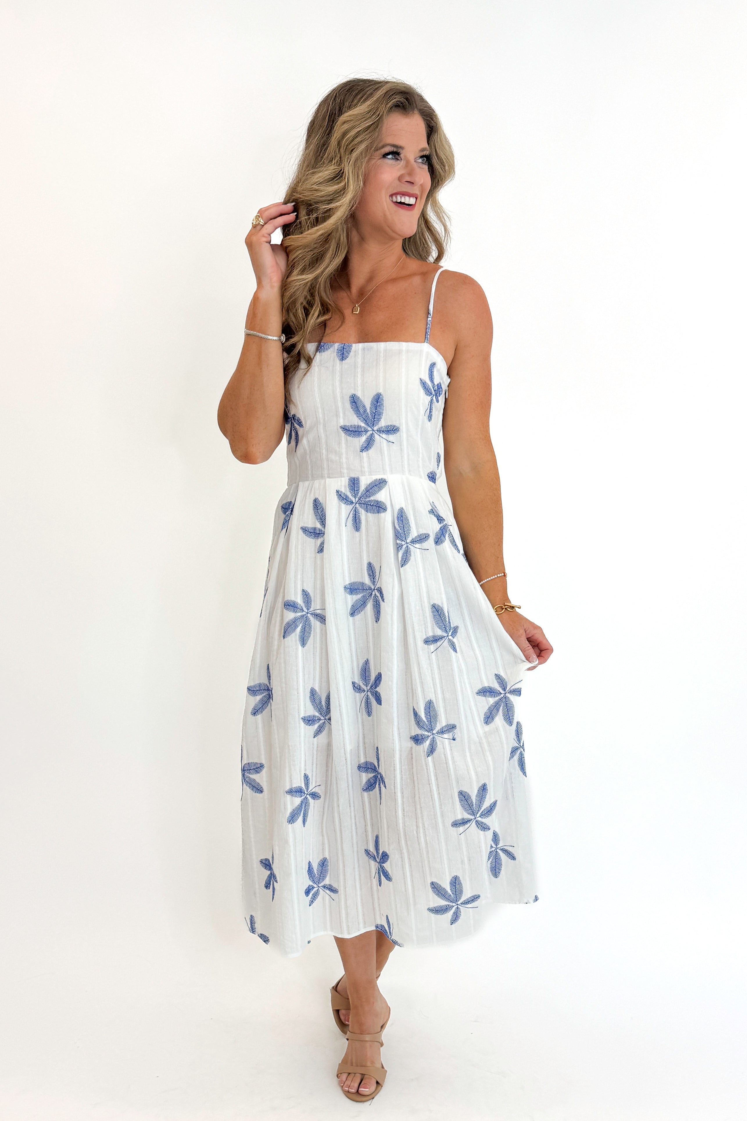 Front view of woman wearing Swagger Boutique’s White With Blue Embroidery Midi Dress against white studio background.