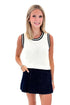 Front view of woman wearing Swagger Boutique’s White With Navy Lining Sweater Tank by Skies Are Blue with skort against white studio background.