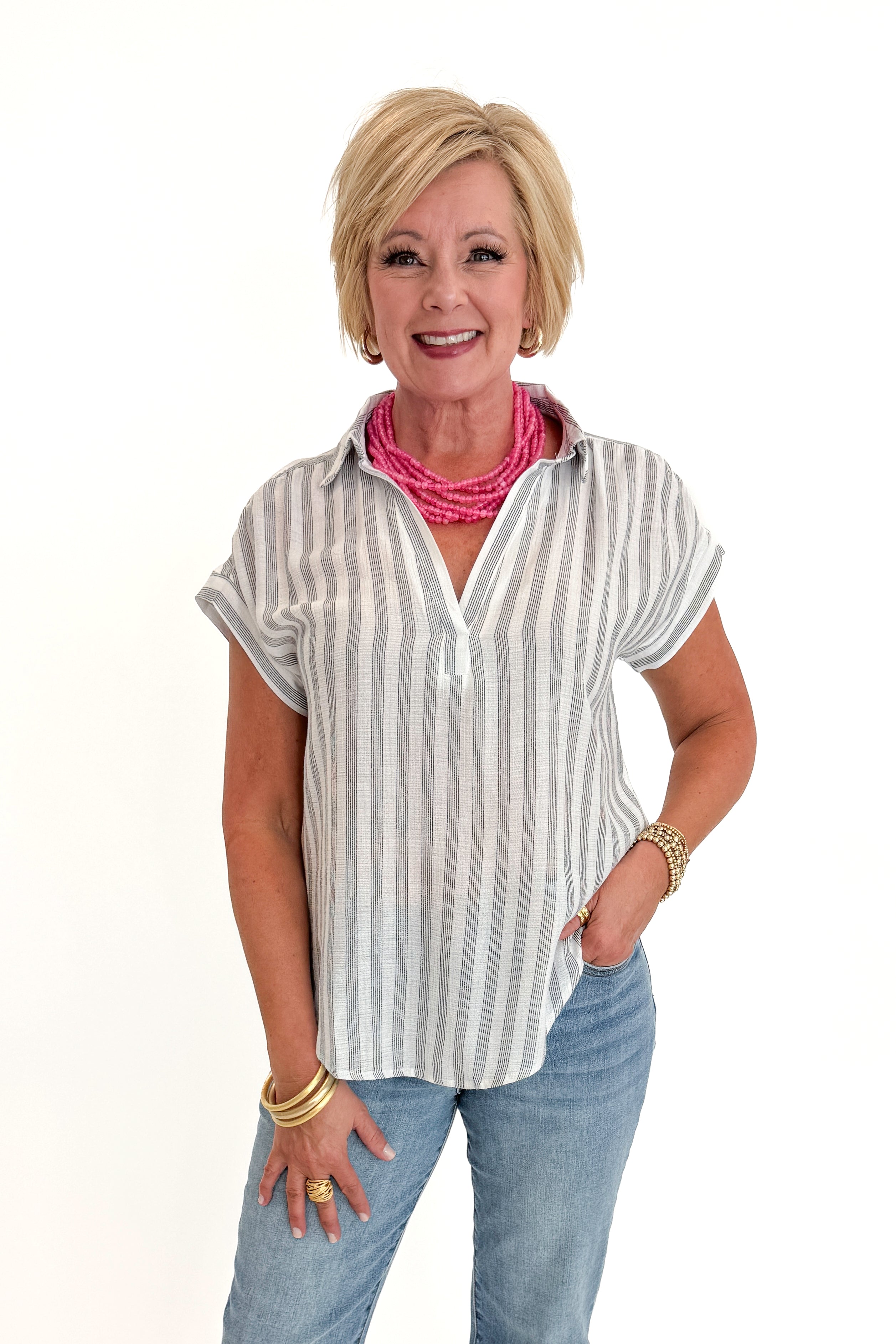 Front view of woman wearing Swagger Boutique’s White &amp; Black Striped Collared Top with jeans and Kaylie necklace against white studio background.