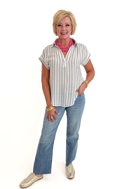 Front view of woman wearing Swagger Boutique’s White &amp; Black Striped Collared Top with jeans and Kaylie necklace against white studio background.