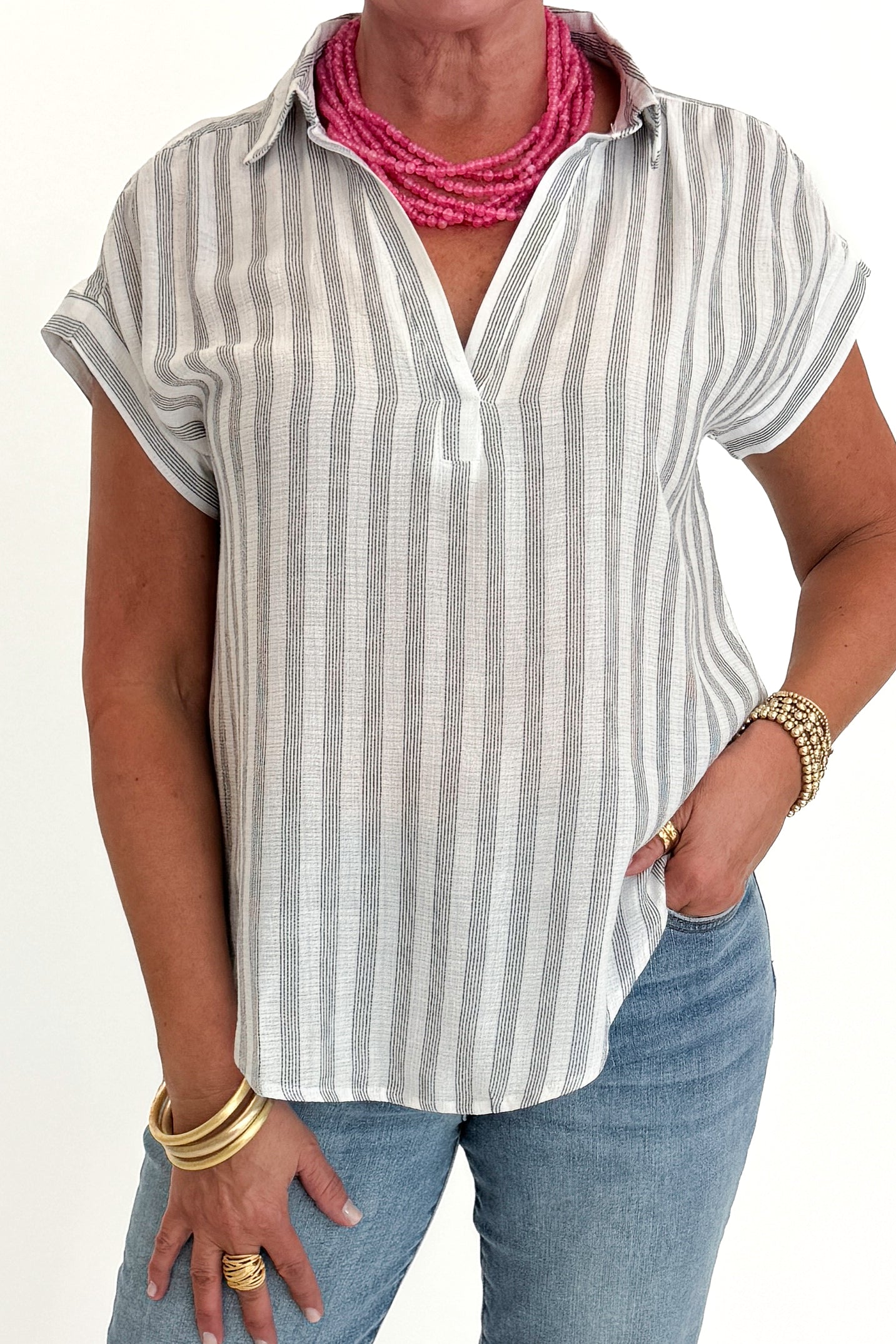 Front detail view of woman wearing Swagger Boutique’s White &amp; Black Striped Collared Top with jeans and Kaylie necklace against white studio background.