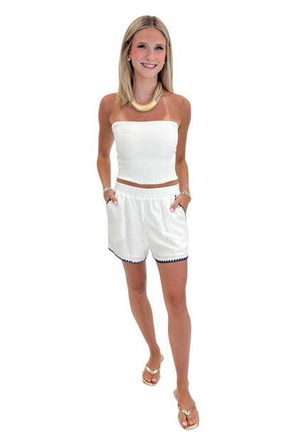 Front view of woman wearing Swagger Boutique’s White &amp; Blue Square Neck Stitch Detail Tank with Off White Ribbed Tube Top against white studio background.