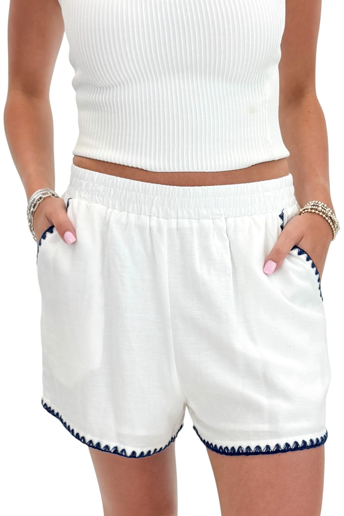 Front detail view of woman wearing Swagger Boutique’s White &amp; Blue Square Neck Stitch Detail Tank with Off White Ribbed Tube Top against white studio background.