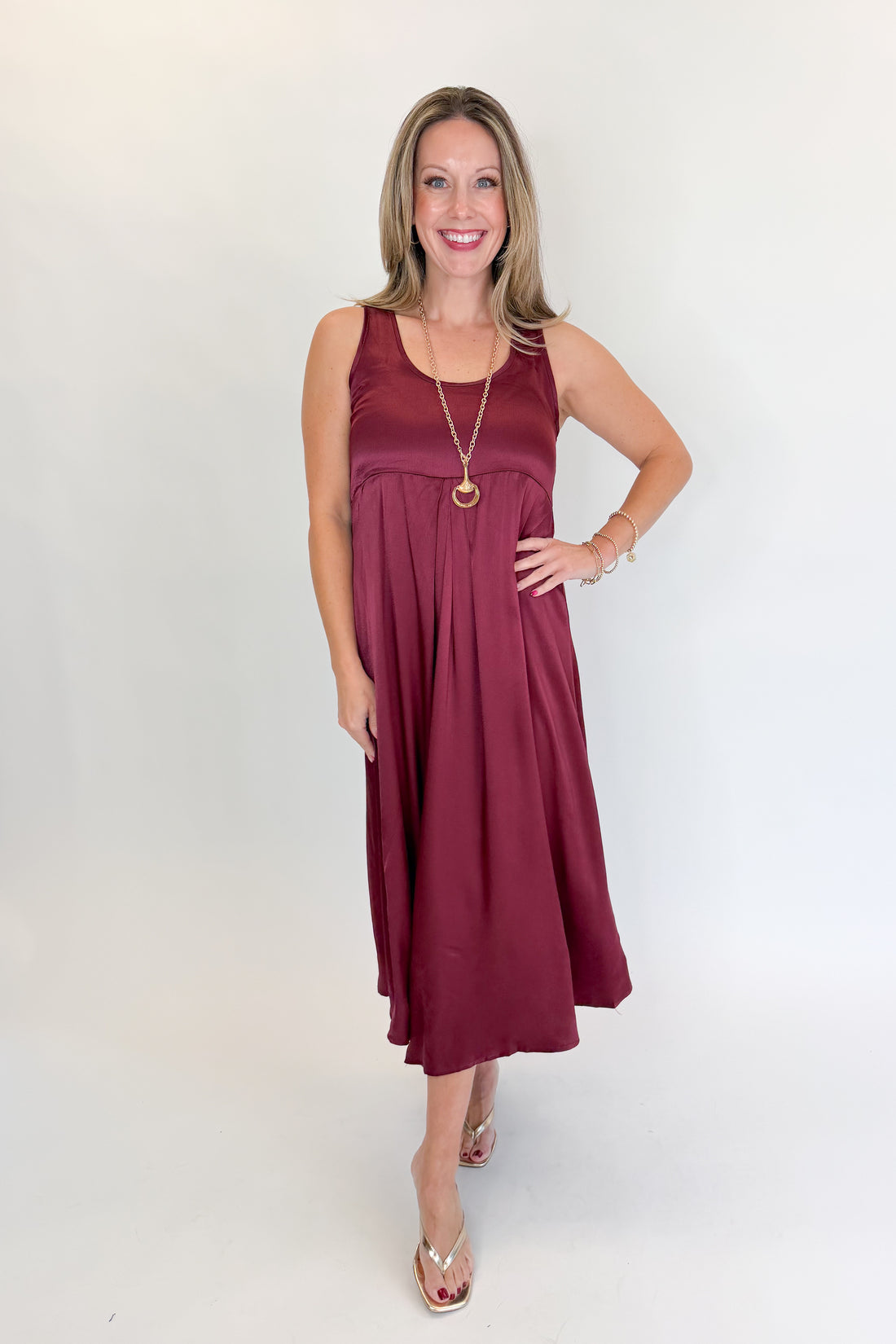 Front view of woman wearing Swagger Boutique’s Wine &amp; Leopard Layered Midi Dress with heels against white studio background.