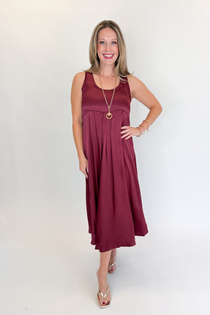 Front view of woman wearing Swagger Boutique’s Wine &amp; Leopard Layered Midi Dress with heels against white studio background.