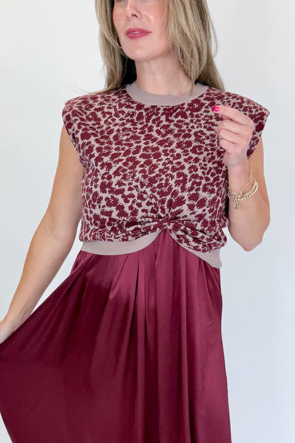 Front detail view of woman wearing Swagger Boutique’s Wine &amp; Leopard Layered Midi Dress with heels against white studio background.
