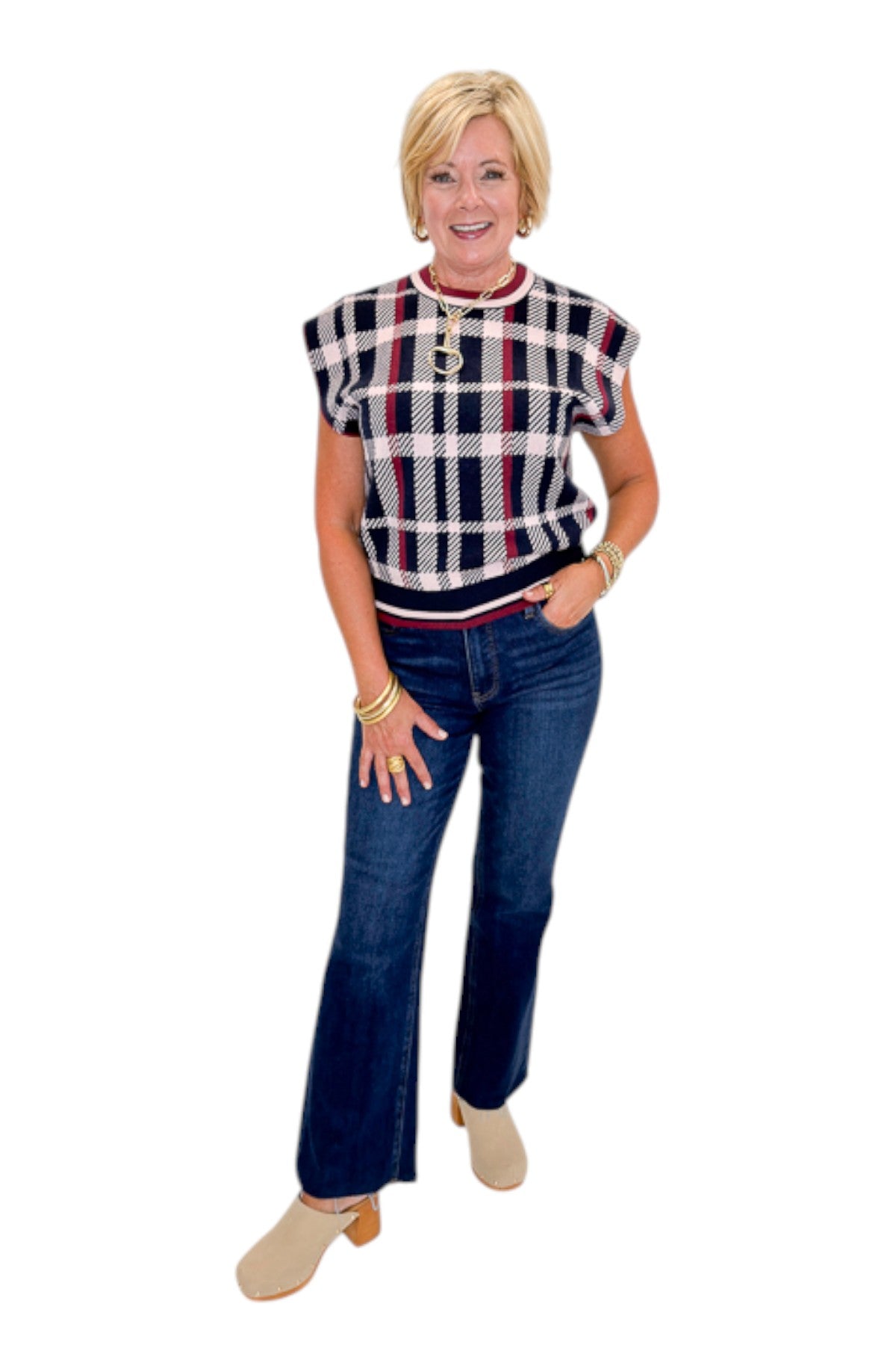 Front view of woman wearing Swagger Boutique’s Wine &amp; Navy Plaid Sleeveless Sweater by THML with jeans against white studio background.