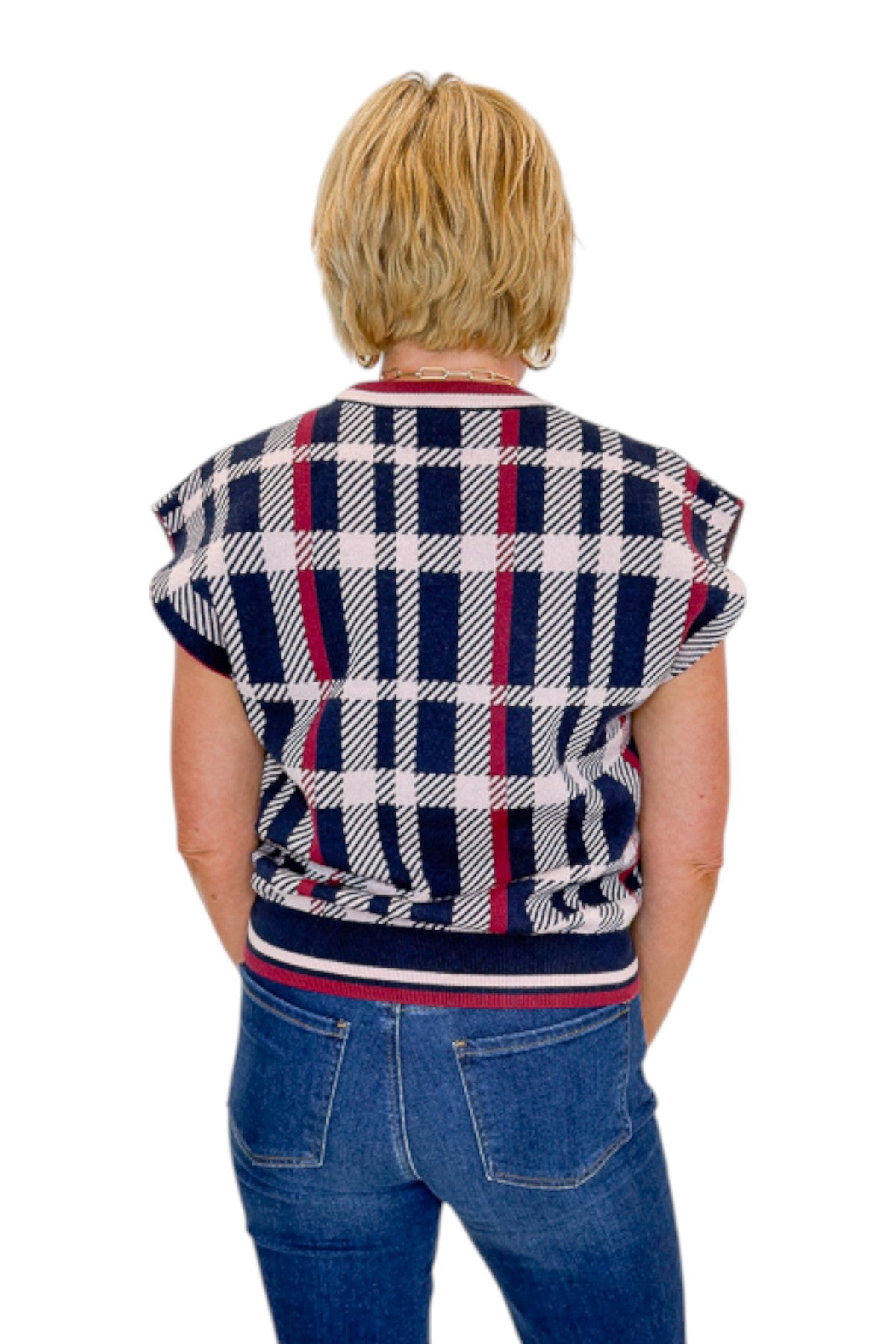 Back view of woman wearing Swagger Boutique’s Wine &amp; Navy Plaid Sleeveless Sweater by THML with jeans against white studio background.