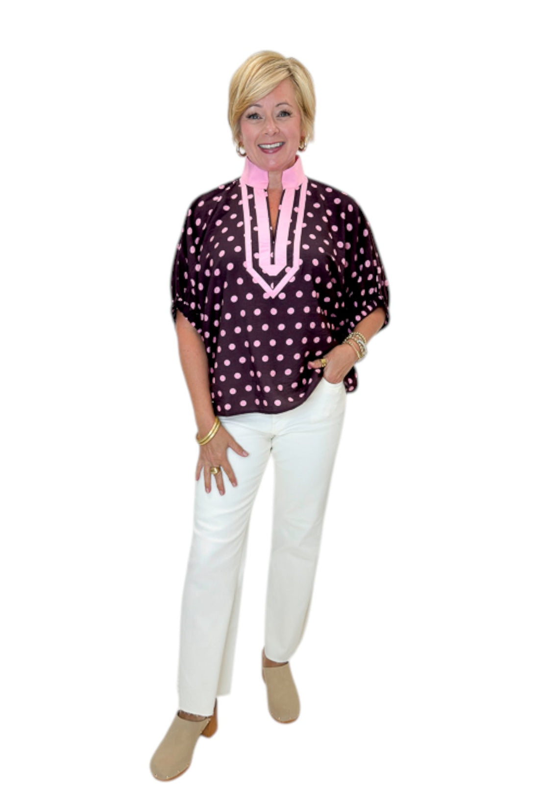 Front view of woman wearing Swagger Boutique’s Wine &amp; Pink Polka Dot Dolman Sleeve Top by Entro with jeans against white studio background.