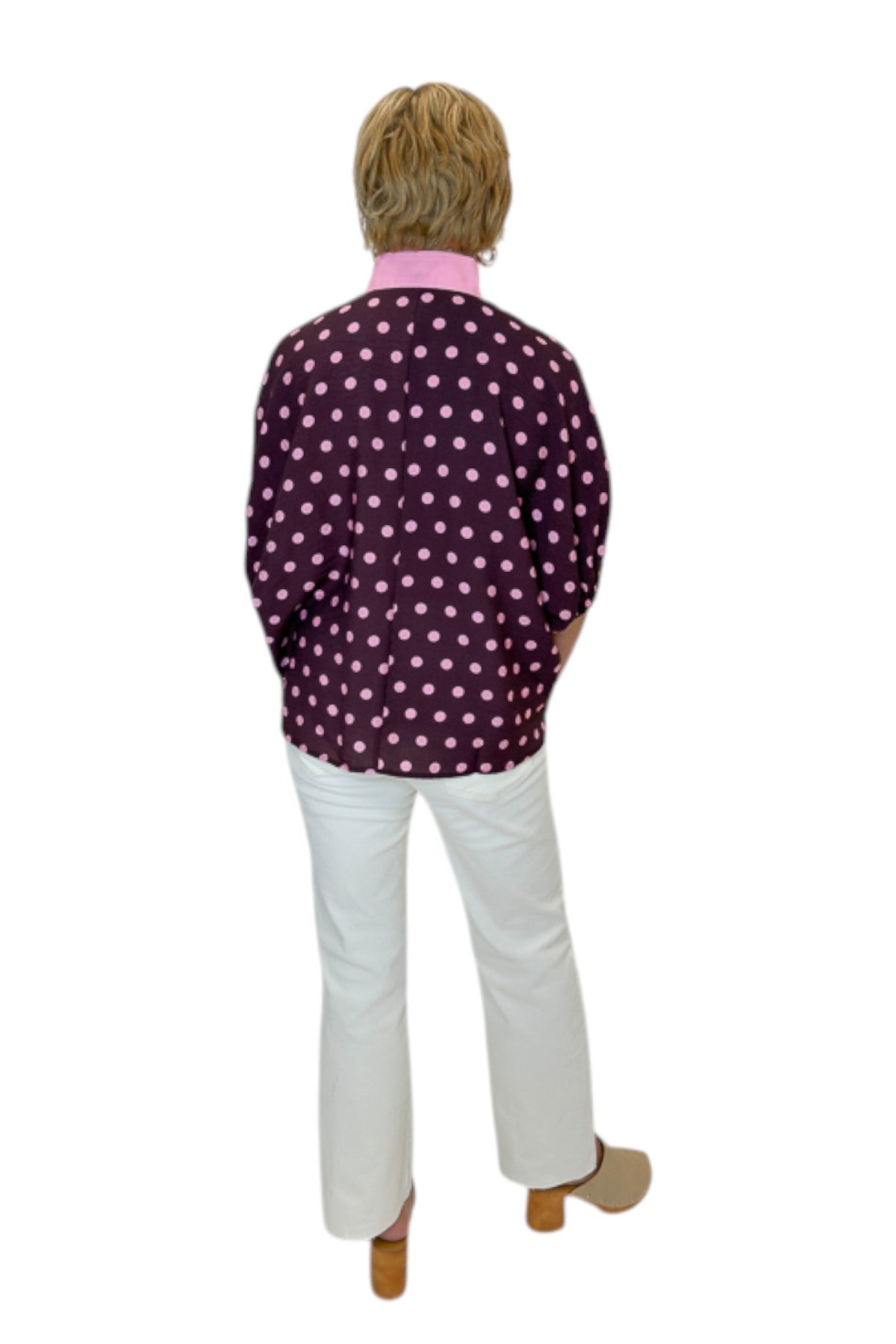 Back view of woman wearing Swagger Boutique’s Wine &amp; Pink Polka Dot Dolman Sleeve Top by Entro with jeans against white studio background.