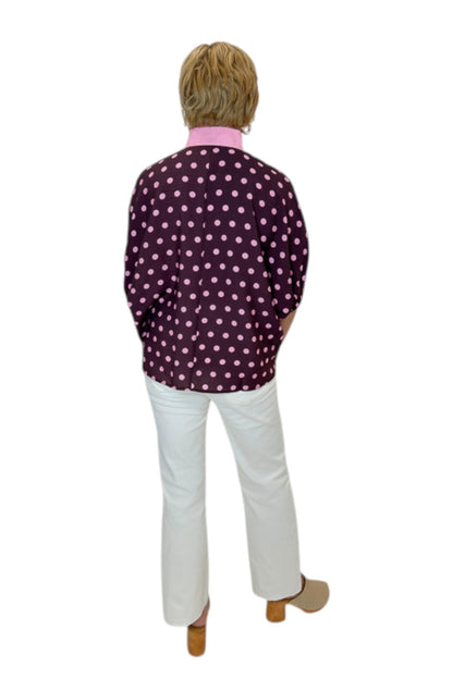 Back view of woman wearing Swagger Boutique’s Wine &amp; Pink Polka Dot Dolman Sleeve Top by Entro with jeans against white studio background.