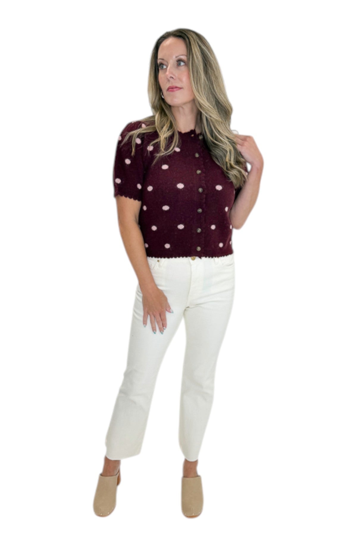 Front view of woman wearing Swagger Boutique’s Wine &amp; Pink Polka Dot Short Sleeve Cardigan by Entro with jeans against white studio background.