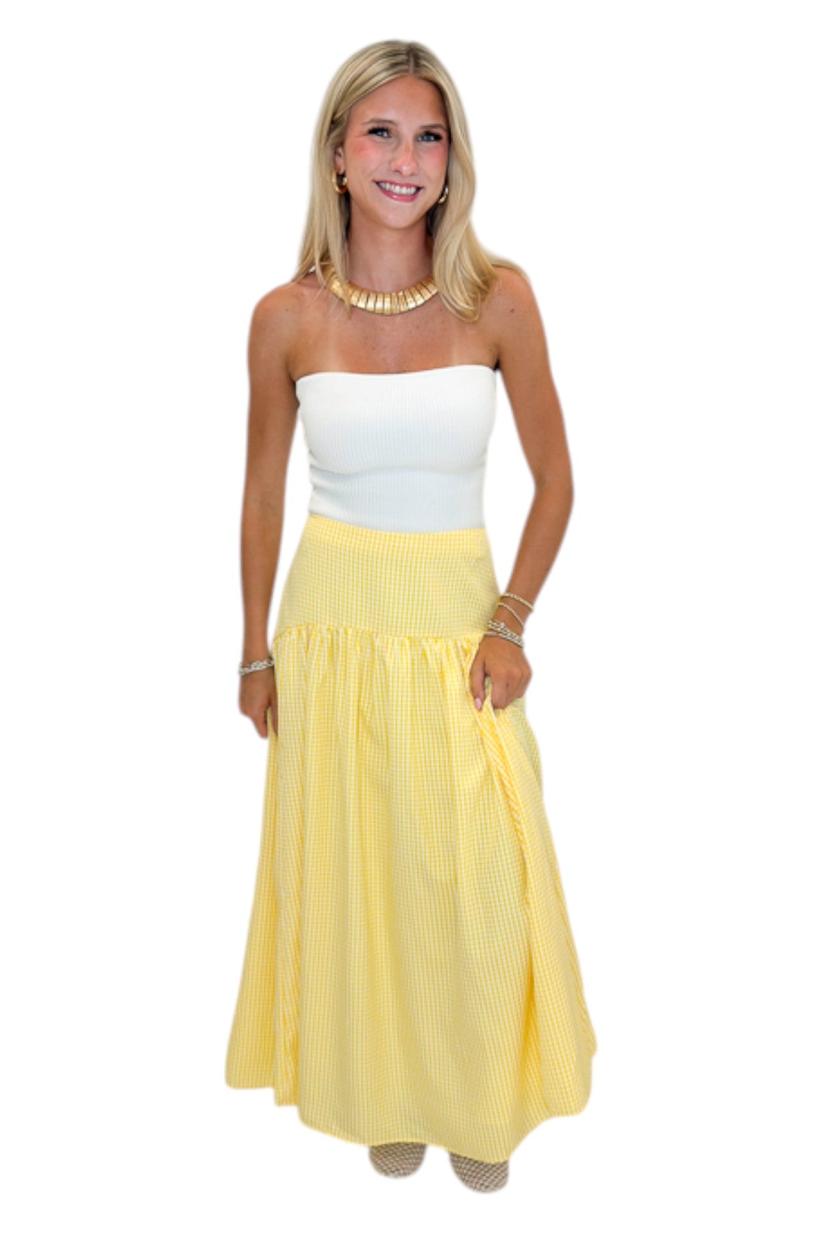 Front view of woman wearing Swagger Boutique’s Yellow Gingham Skirt with white top against white studio background.