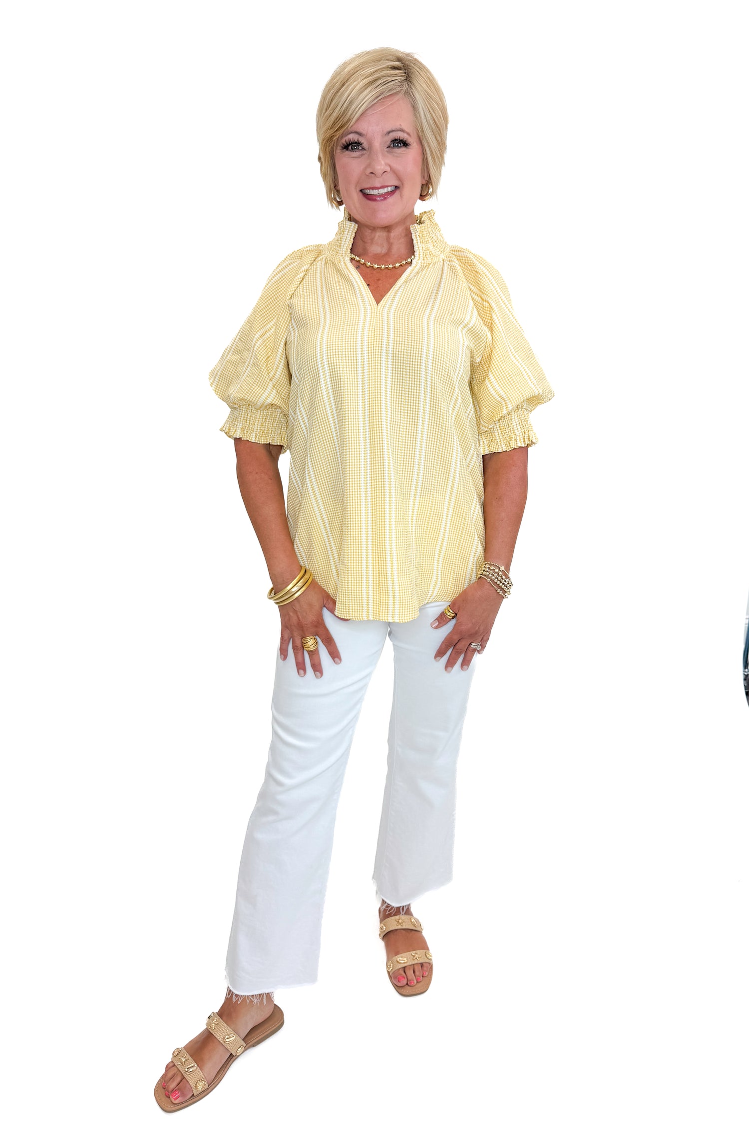 Front view of woman wearing Swagger Boutique’s Yellow Striped Puff Sleeve Top with jeans against white studio background.